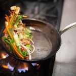 Sauteing the ingredients for Pancit Canton, a stir-fried noodle dish </br>